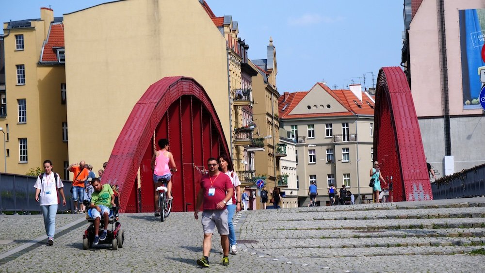 Poznan distinct bridge with walking pedestrians and bicycle riders in Poland