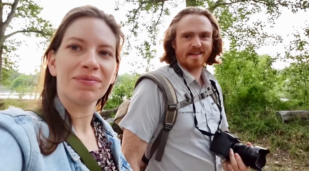 Samuel Jeffery and Audrey Bergner Walking in Prince's Island Park, Calgary, Alberta, Canada Audrey Bergner and Samuel Jeffery holding a camera and backpack while walking along a lush tree-lined pathway at Prince's Island Park in Calgary, Alberta, Canada.