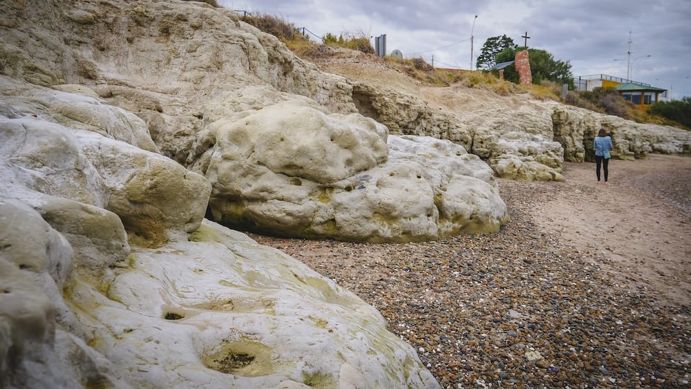 Puerto Madryn Mimosa landing site in Patagonia where Welsh settlers first arrived in Argentina in 1865 Rocky coastline and caves near Puerto Madryn, Patagonia, where Welsh settlers first arrived aboard the Mimosa in 1865, highlighting the harsh, barren landscape that shaped the survival-driven tea culture later seen in Gaiman and Trevelin.