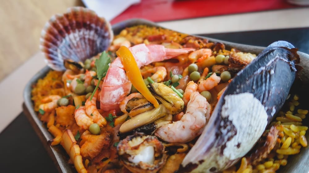 Puerto Madryn seafood paella with shellfish highlighting Atlantic coastal Patagonia cuisine Puerto Madryn Patagonia Argentina seafood paella with shrimp mussels and shellfish, showcasing Atlantic coastal cuisine and Spanish culinary influence, highlighting the diverse seafood traditions found along Patagonia’s eastern shoreline