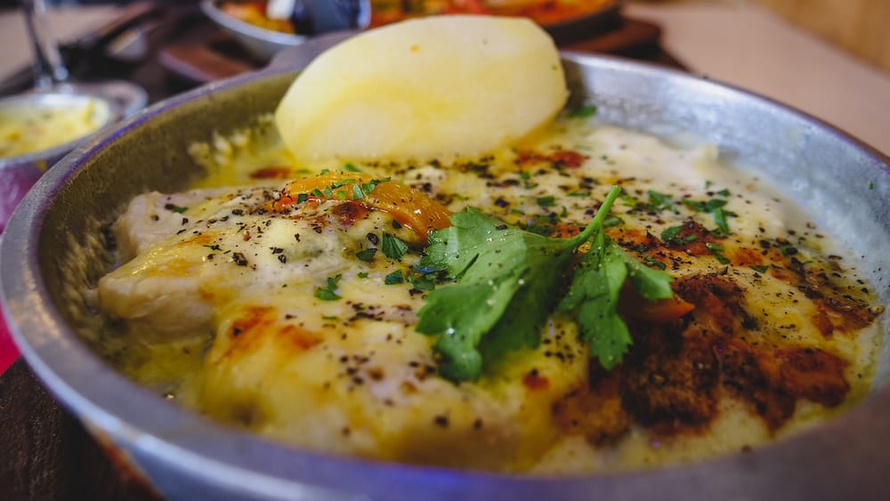 Puerto Madryn seafood at Cantina El Nautico with Roquefort salmon and squid Seafood dish with Roquefort salmon, squid, and herbs at Cantina El Nautico in Puerto Madryn Patagonia Argentina highlighting the region’s rich Atlantic coastal cuisine