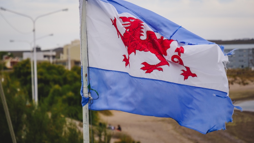 Welsh flag flying in Puerto Madryn highlighting Patagonia’s Welsh cultural heritage Puerto Madryn Welsh flag waving above the Patagonian Atlantic coast in Chubut Argentina reflecting the region’s unique Welsh heritage that dates back to the 1865 Welsh settlers who founded communities across the steppe.