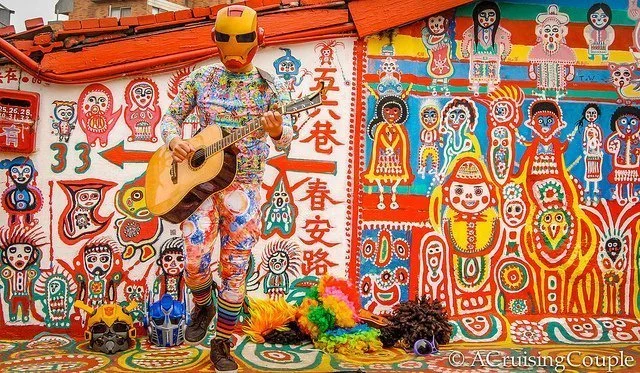 Rainbow Village Taichung, Taiwan with a man dressed up and playing the guitar