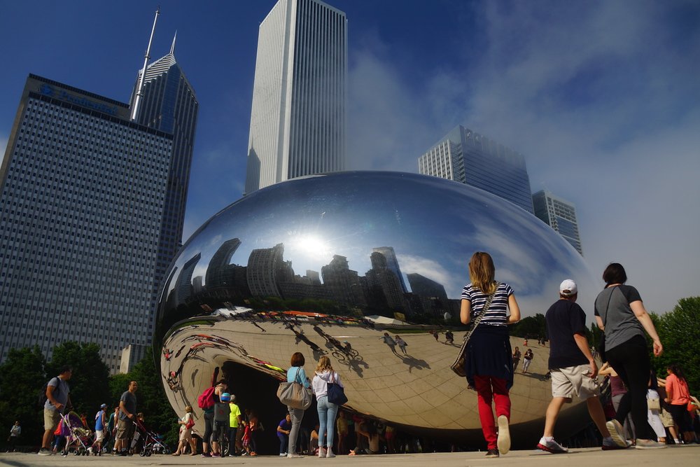 Reflection and photography from the Cloud Gate also known as the Bean in Chicago with That Backpacker approaching