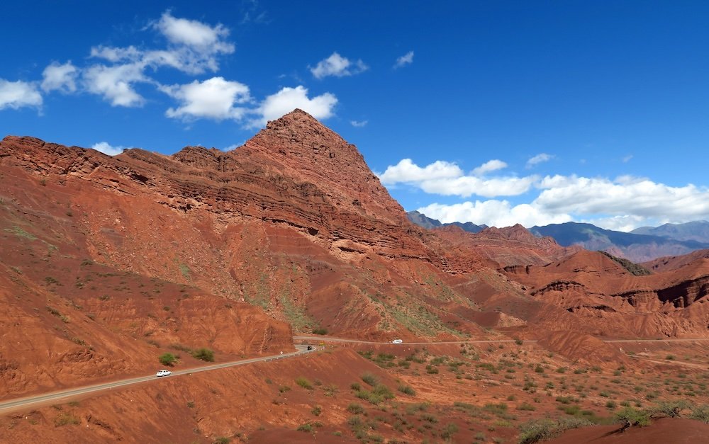 Remarkable scenery outside of Salta, Argentina with road scene and red mountains in the background 