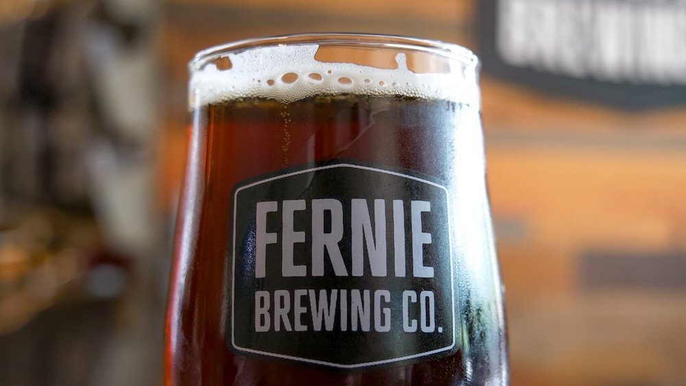 Ridgewalk Red Ale at Fernie Brewing Company Ridgewalk Red Ale served in a Fernie Brewing Company glass inside the tasting room in Fernie, British Columbia, highlighting the deep amber colour and creamy head of this malty red ale that makes a perfect post-hike reward for visitors exploring the Canadian Rockies.