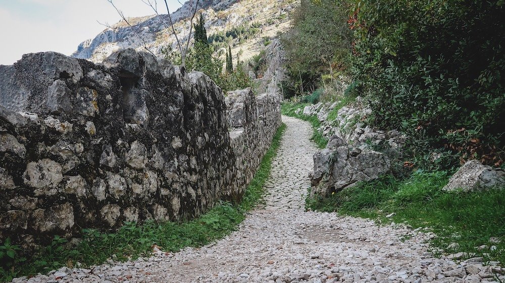 Rustic pathway in Kotor, Montenegro with side wall 