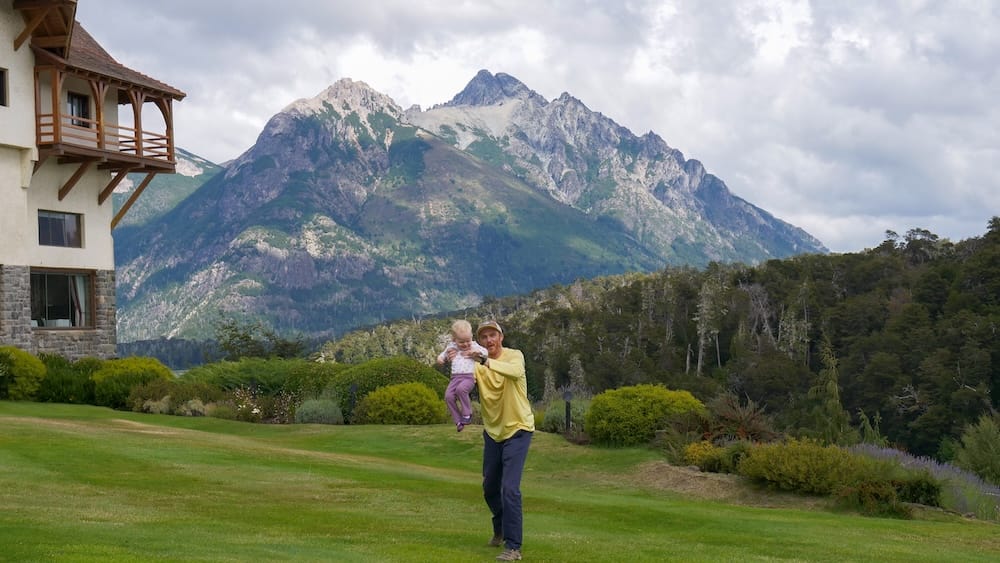 Samuel Jeffery and Aurelia Jeffery at Llao Llao Hotel Gardens in Bariloche During Late Summer Samuel Jeffery holding Aurelia Jeffery in the Llao Llao Hotel gardens near Bariloche, Río Negro, during late summer, showing the calmer family-friendly side of Patagonia just before shoulder season begins.