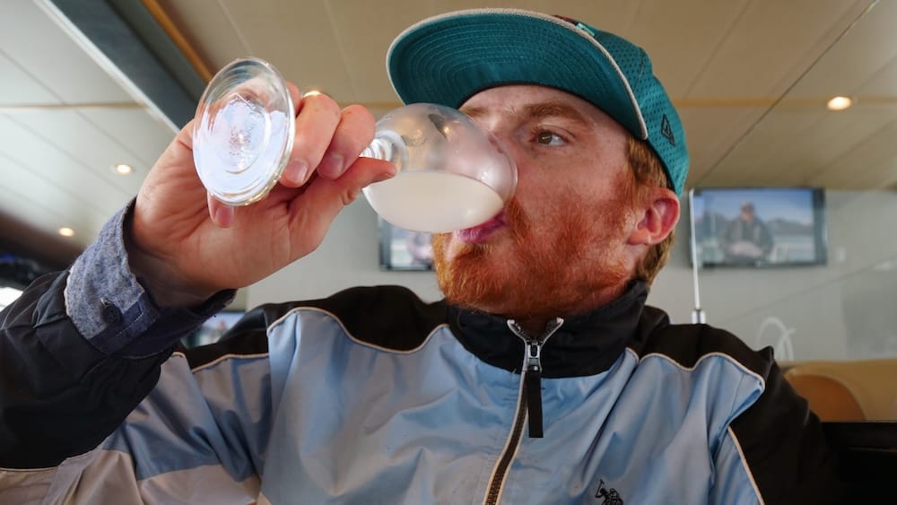 Samuel Jeffery drinking grapefruit juice with glacier ice on an El Calafate boat tour in Patagonia Samuel Jeffery drinks grapefruit juice chilled with glacier ice inside the boat during a full-day navigation from El Calafate through the icy landscapes of Lago Argentino in Patagonia, Argentina.