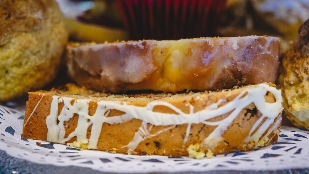 Glazed Loaf Cakes and Patagonian Pastries in San Martín de los Andes Neuquén Bakery Scene Glazed loaf cake slices and dense pastries in San Martín de los Andes Neuquén, representing Patagonia’s lake district baking style where simple, sturdy cakes deliver reliable calories and pair naturally with merienda or coffee.
