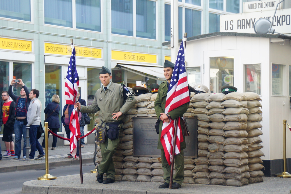 Soldiers standing outside of Checkpoint Charlie in Berlin, Germany