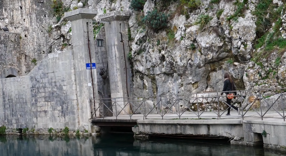 South Gate entrance in Kotor, Montenegro with That Backpacker Audrey Bergner walking in