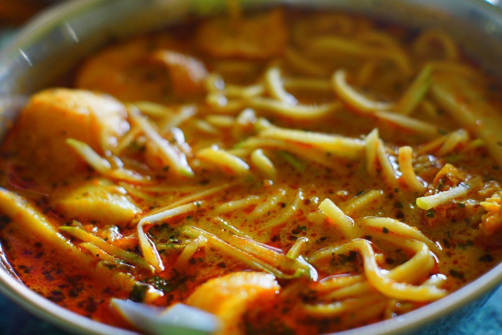 Spicy and colorful laksa in a bowl in Malacca, Malaysia 