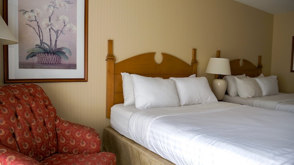 St. Eugene Golf Resort & Casino in Cranbrook, British Columbia, showing a comfortable guest room with two neatly made beds, soft lighting, and classic décor, illustrating the practical and family-friendly accommodations during our overnight stay.