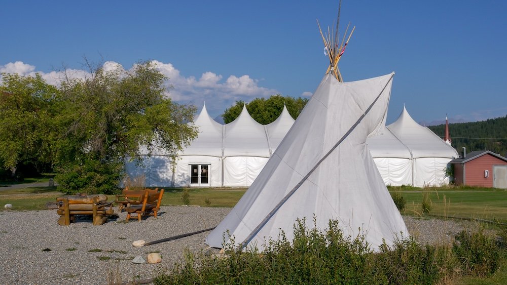 St. Eugene Golf Resort & Casino near Cranbrook, British Columbia, showing a traditional tipi and gathering area on the grounds, representing the Ktunaxa Nation’s presence and the Indigenous history connected to the former mission site.