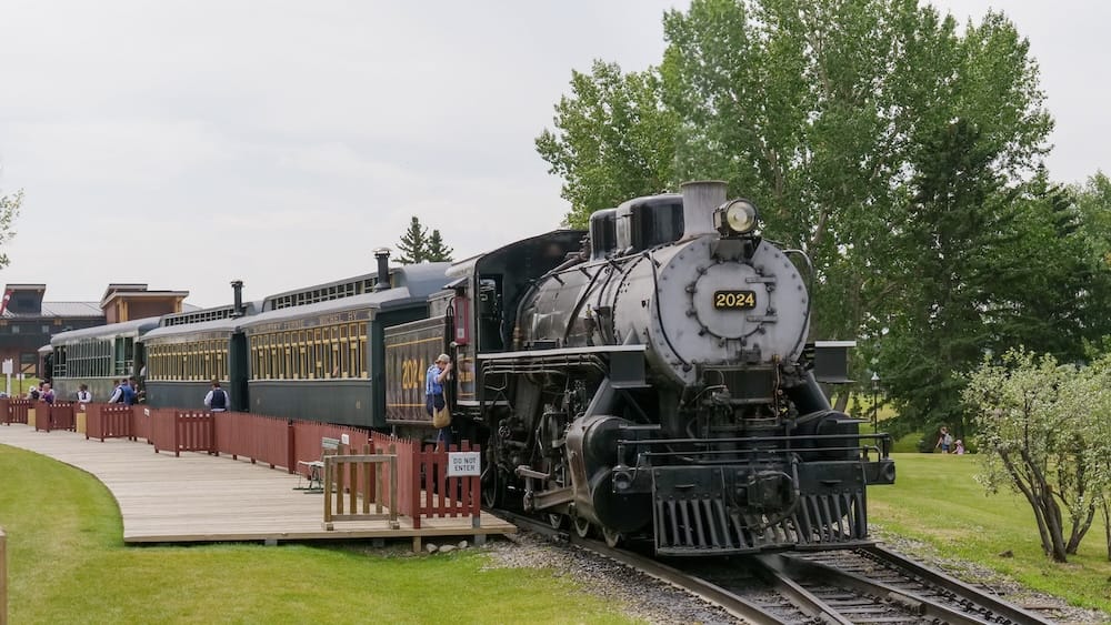 Steam train, Heritage Park Historical Village, Calgary, Alberta, Canada A vintage steam locomotive numbered 2024 pulling passenger cars along the boardwalk at Heritage Park Historical Village, Canada's largest living history museum in Calgary, Alberta.