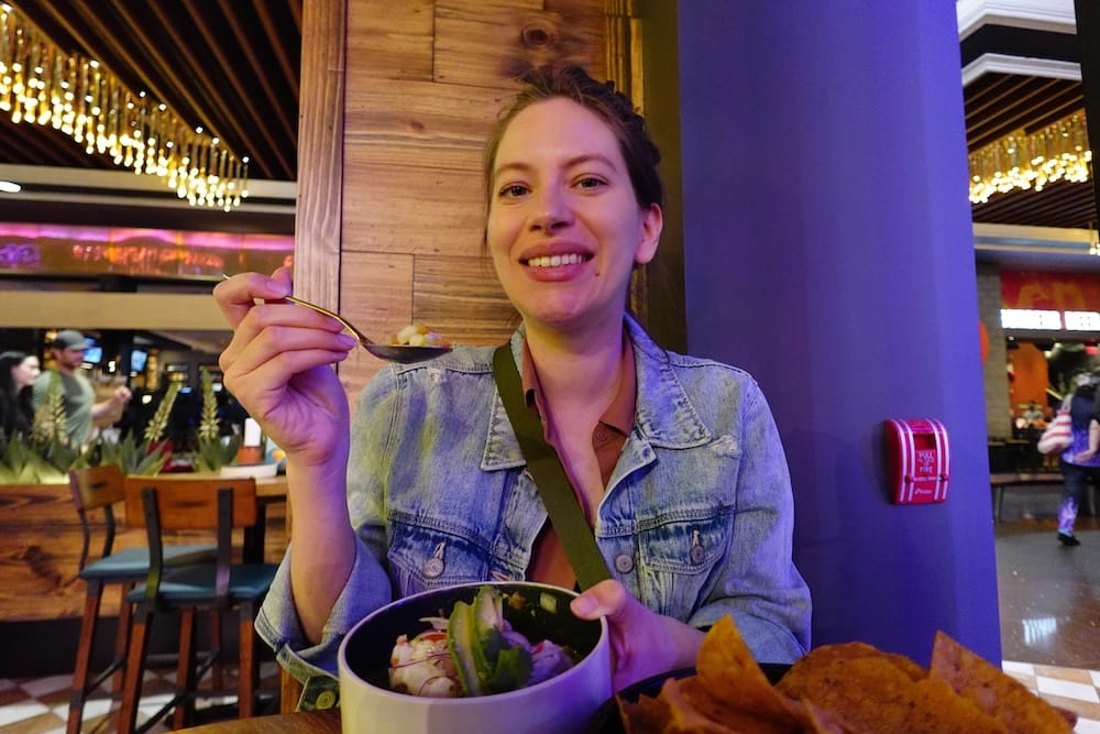 Audrey Bergner Eating Ceviche at The Taco Shop in West Edmonton Mall, Edmonton, Alberta, Canada Audrey Bergner eats ceviche at The Taco Shop in West Edmonton Mall, Edmonton, Alberta, Canada, with avocado-topped ceviche in a bowl and tortilla chips on the table.