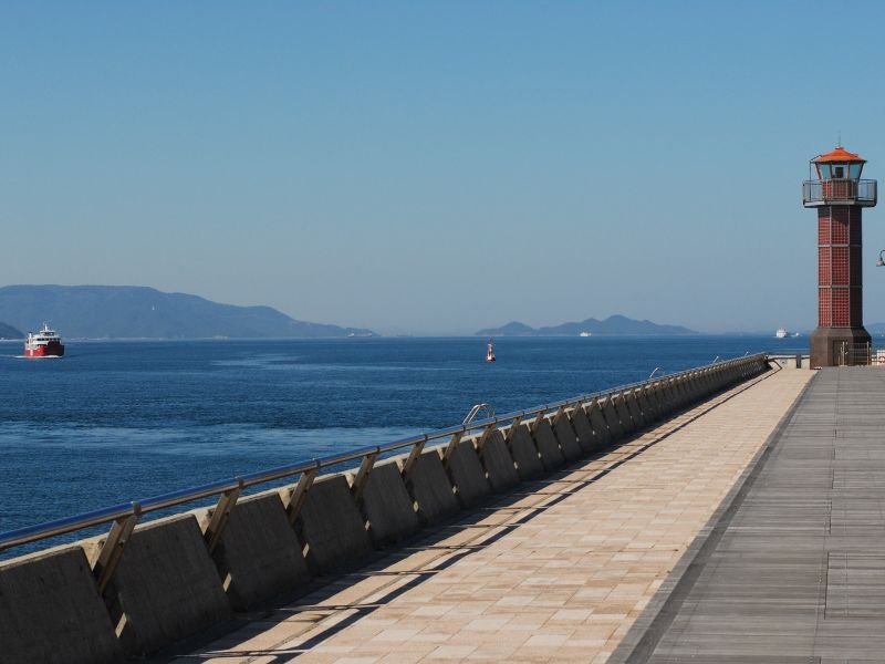 Takamatsu coastal views with boardwalk and ferry coming into the port in Japan