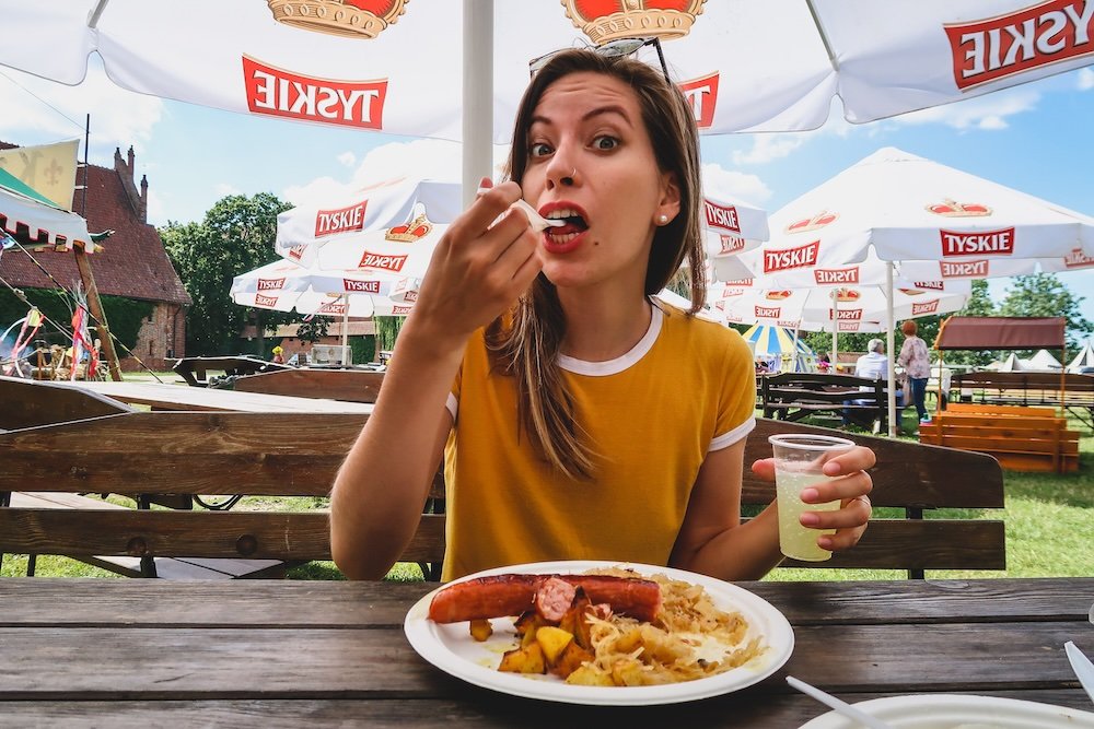 That Backpacker Audrey Bergner eating classic Polish food at Malbork Castle, Poland 