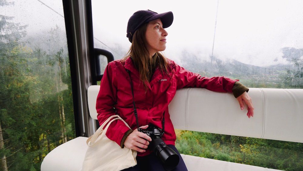 That Backpacker Audrey Bergner enjoying A Cable Car Ride Up Jenner Mountain with camera in hand while visiting Berchtesgaden, Germany 