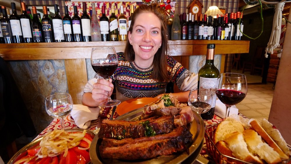 That Backpacker Audrey Bergner enjoying asado and Argentine red wine in Tolhuin, Tierra del Fuego, Argentina 