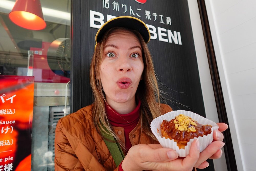 That Backpacker Audrey Bergner enjoying sweet street food snacks in Nagano city, Japan 