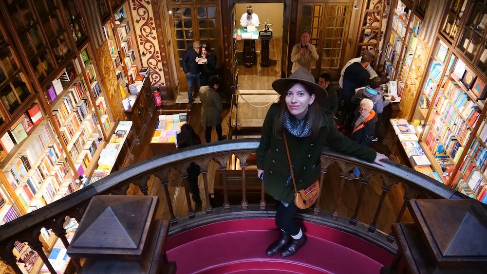 That Backpacker Audrey Bergner enjoys views from the balcony inside Lello Bookstore Livraria Lello one of the world’s most beautiful bookstores in Porto, Portugal