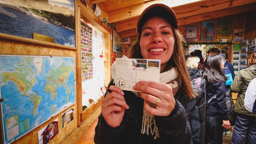 That Backpacker Audrey Bergner excited about sending a postcard from a post office at the end of the world in Tierra del Fuego National Park, Ushuaia, Argentina 