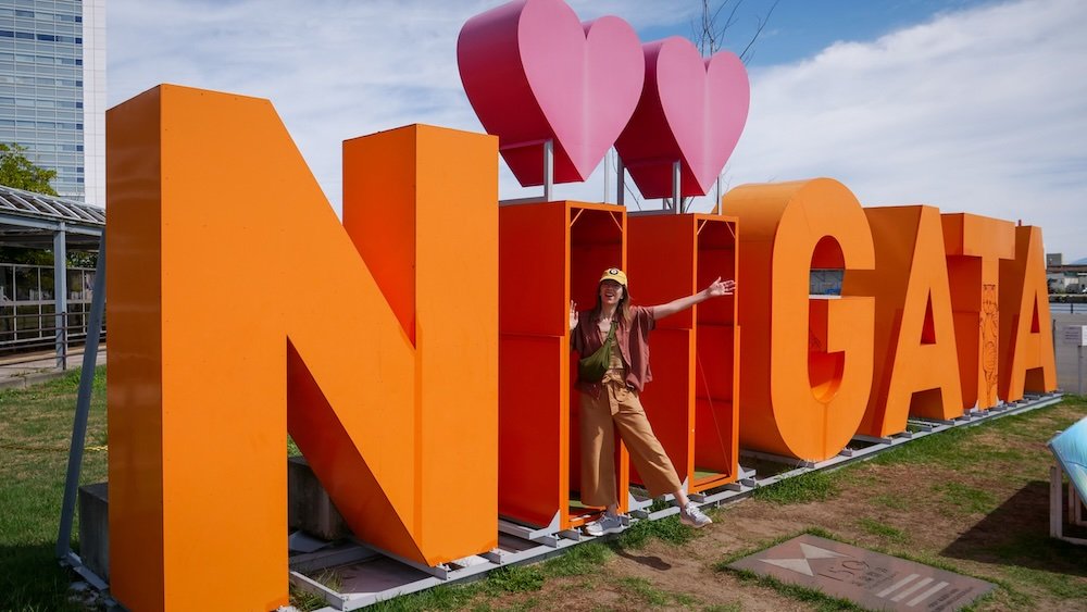 That Backpacker Audrey Bergner excited to be visiting Niigata, Japan by love Niigata sign