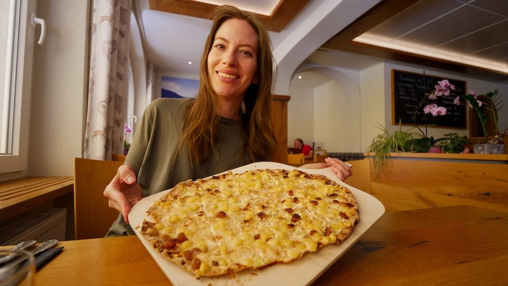 That Backpacker Audrey Bergner holding a giant German pizza in the Black Forest, Germany 