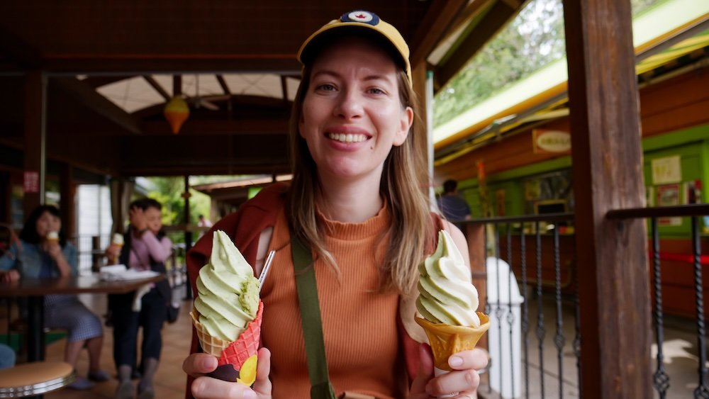 That Backpacker Audrey Bergner holding delicious wasabi ice creams in her hands at Daio Wasabi Farm in Japan