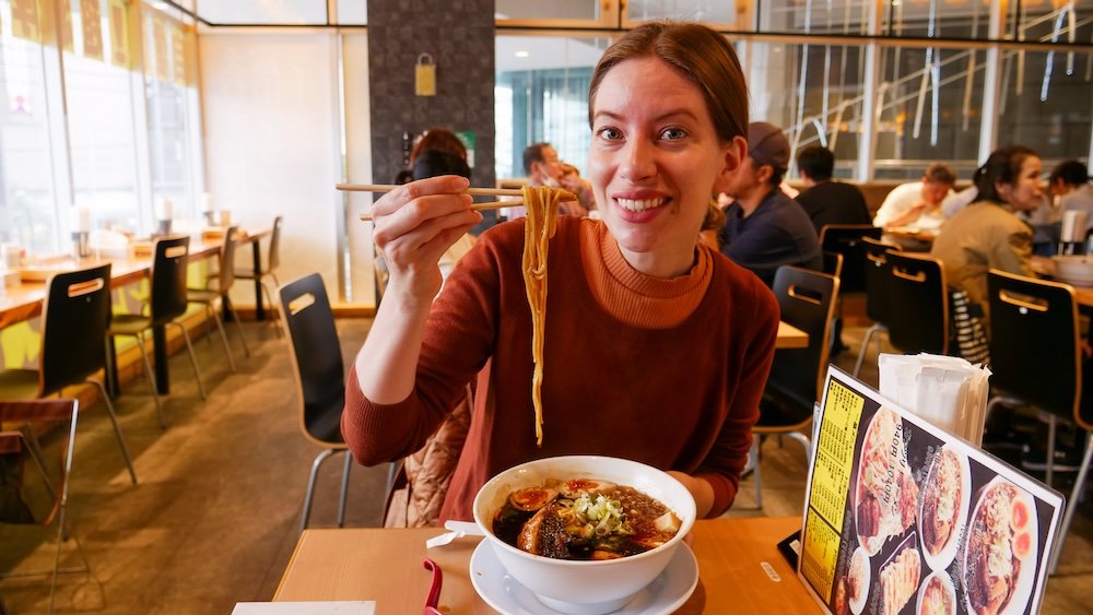 That Backpacker Audrey Bergner holding Japanese ramen noodles with chopsticks 