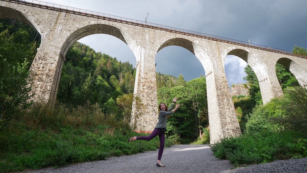 That Backpacker Audrey Bergner jumping for joy outside of the Ravenna Viaduct an architectural marvel a towering railway bridge stretching majestically over a deep gorge