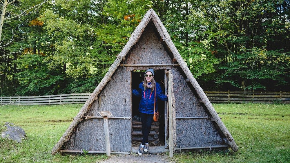 That Backpacker Audrey Bergner posing by an a-frame home at the Tyrolean Farmhouse Museum (Museum Tiroler Bauernhöfe) in Tyrol, Austria