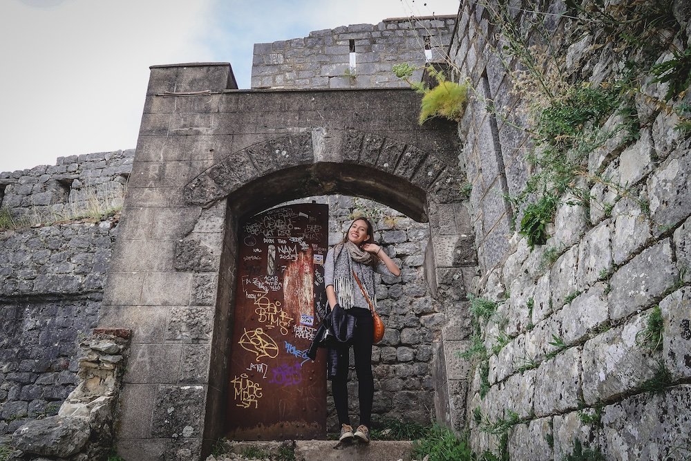 That Backpacker Audrey Bergner posing outside of a door located at St John Fortress in Kotor, Montenegro 