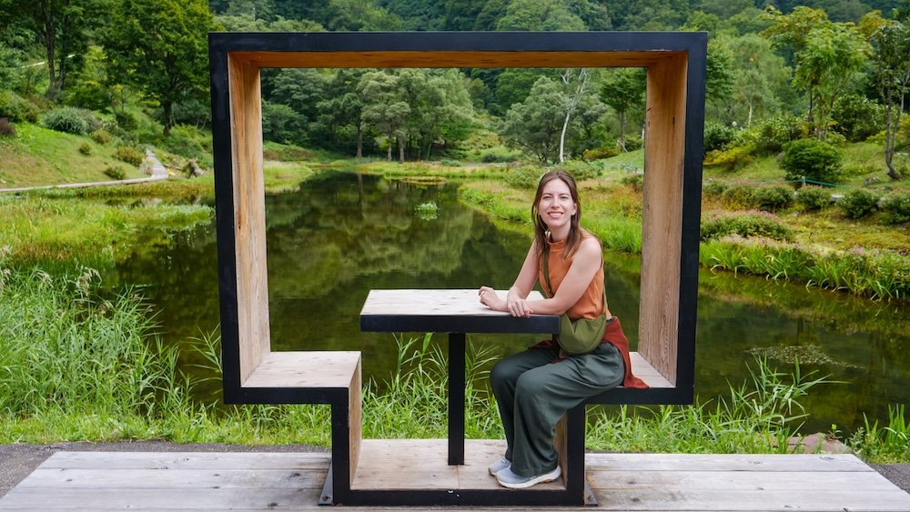 That Backpacker Audrey Bergner visiting Yuzawa, Japan sitting down in a scenic area 