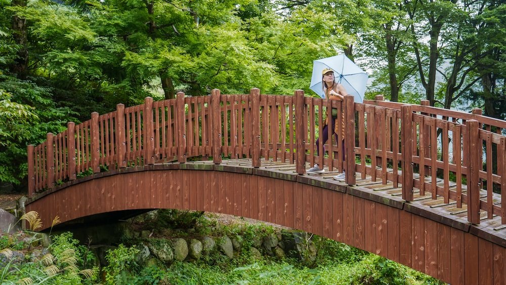 That Backpacker Audrey Bergner walking across a bridge in Yuzawa, Niigata prefecture, Japan 