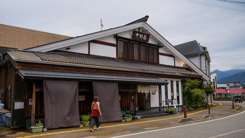 That Backpacker Audrey Bergner walking by traditional architecture in Yuzawa, Japan 