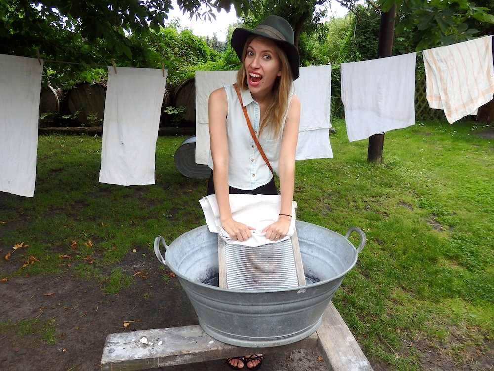 That Backpacker Audrey Bergner washing clothes in a traditional manner at the Freilandmuseum Lehde Open-Air Museum in the Spreewald small village of Lehde, Germany 