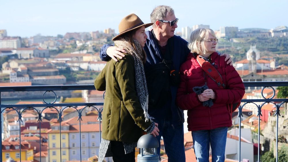 That Backpacker Audrey Bergner with Nomadic Samuel's parents on the main bridge in Porto, Portugal with Ponte Dom Luis I Bridge for the best views of Porto, Portugal 