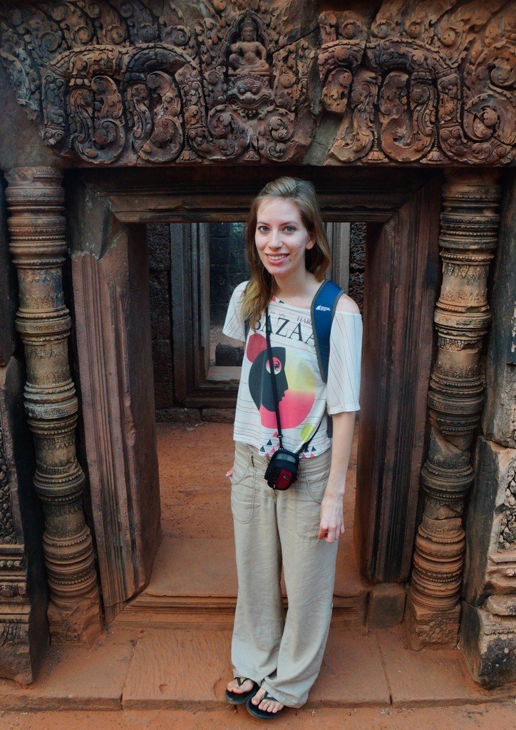 The doorways are tiny as modeled here by Audrey Bergner at Banteay Srei in Cambodia 