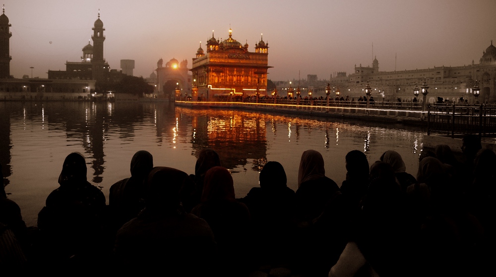 This group of people marvel at the Harmandir Sahib from a distance in the Golden Temple in Amritsar 