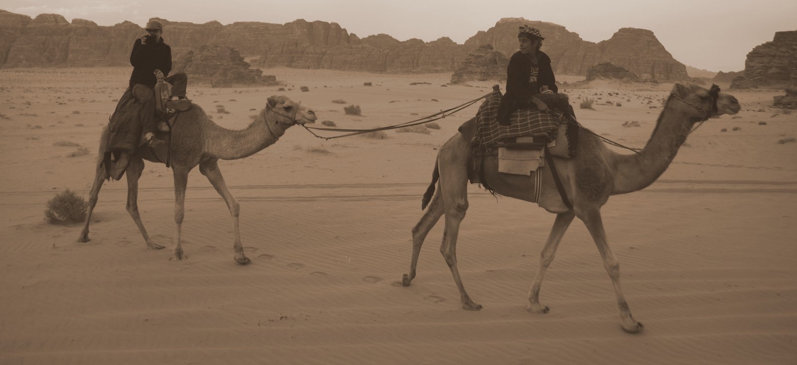 This is an action shot of a Bedouin boy and Dustin Main riding camels in Wadi Rum, Jordan. You'll notice Dustin wielding his dSLR camera in his hands. 