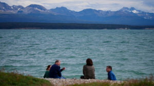 Tolhuin lake views with mountains in the background and people enjoying a snack and social time in Argentina 