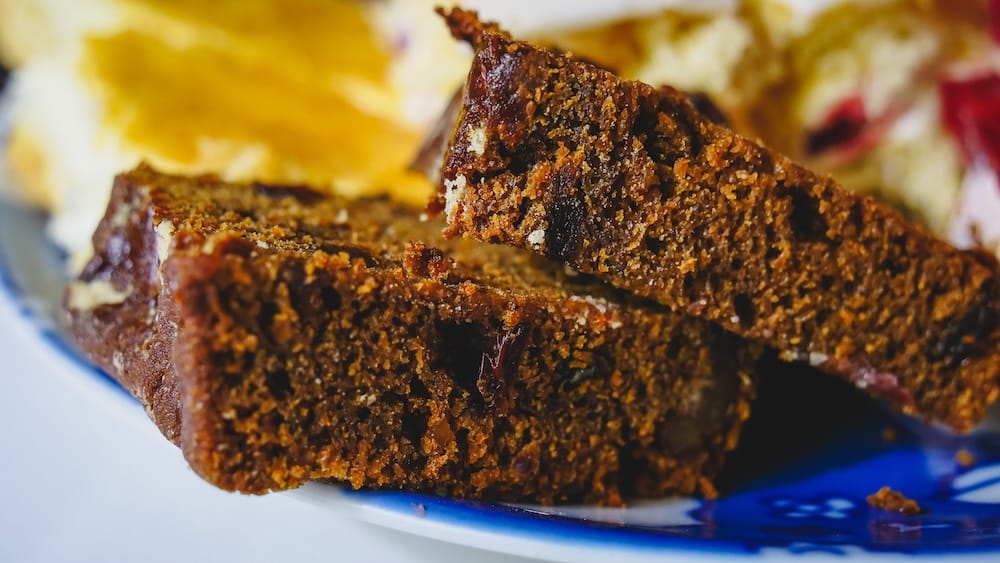 Torta negra Gaiman Patagonia Welsh fruit cake macro survival food tradition Chubut Valley Argentina Macro view of torta negra in Gaiman Patagonia Argentina showing dense fruit cake texture rooted in Welsh settlers survival food traditions, reflecting preserved recipes linked to long voyages, storage, and adaptation in the Chubut Valley