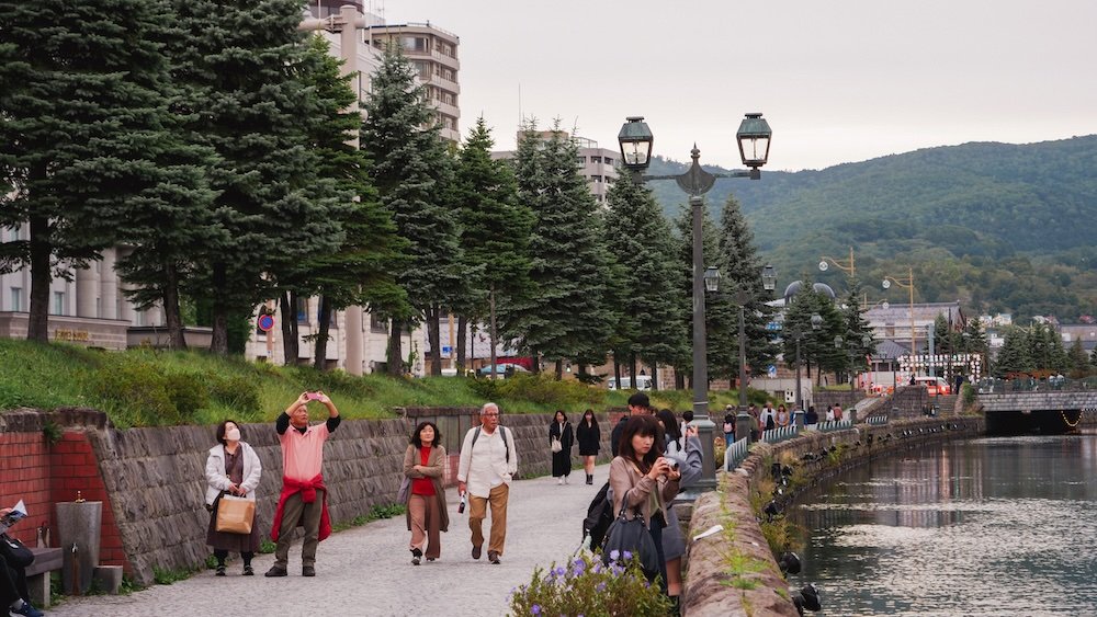 Tourists strolling and taking in scenic Otaru, Japan 