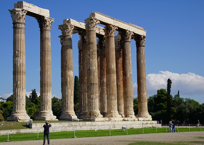 Tourists taking photos of the Temple of Zeus at Olympia in Athens, Greece