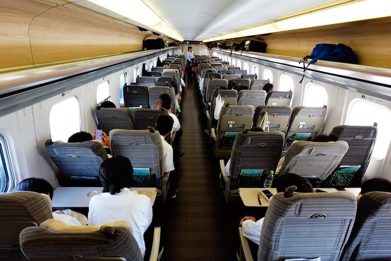 Train travel in Japan with an overhead inside view of the interior of the Shinkansen heading from Tokyo to Hokkaido 