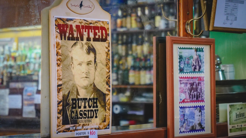 Trelew Patagonia Butch Cassidy wanted poster displayed inside a historic bar in Chubut Argentina, referencing the famous outlaw who once hid in the Welsh settlement region while fleeing Pinkerton detectives in early 20th century Patagonia.