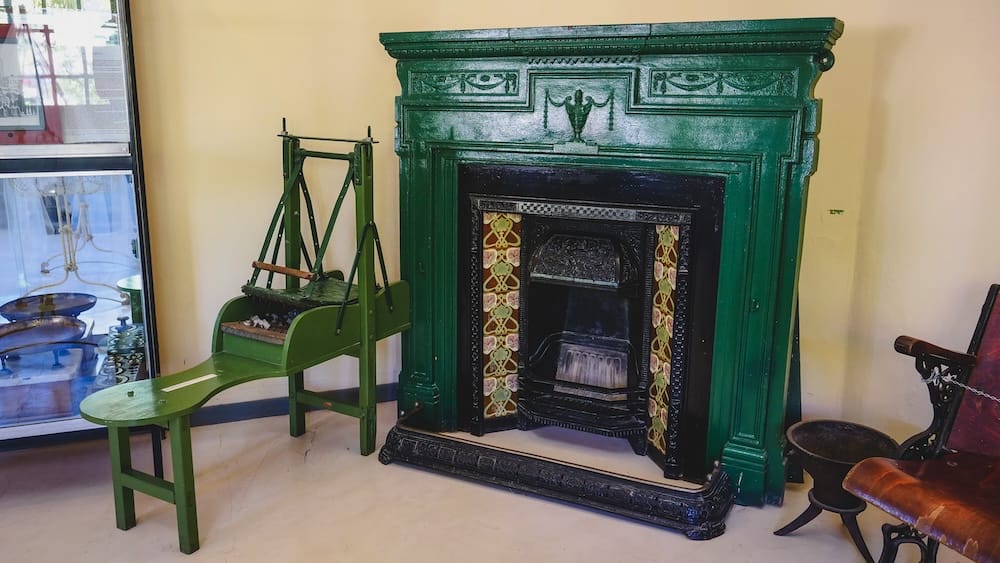 Historic Welsh household artifacts in Trelew, Patagonia, including a painted fireplace and traditional tools, preserving the domestic life and cultural traditions brought by Welsh settlers who established enduring communities in southern Argentina.
